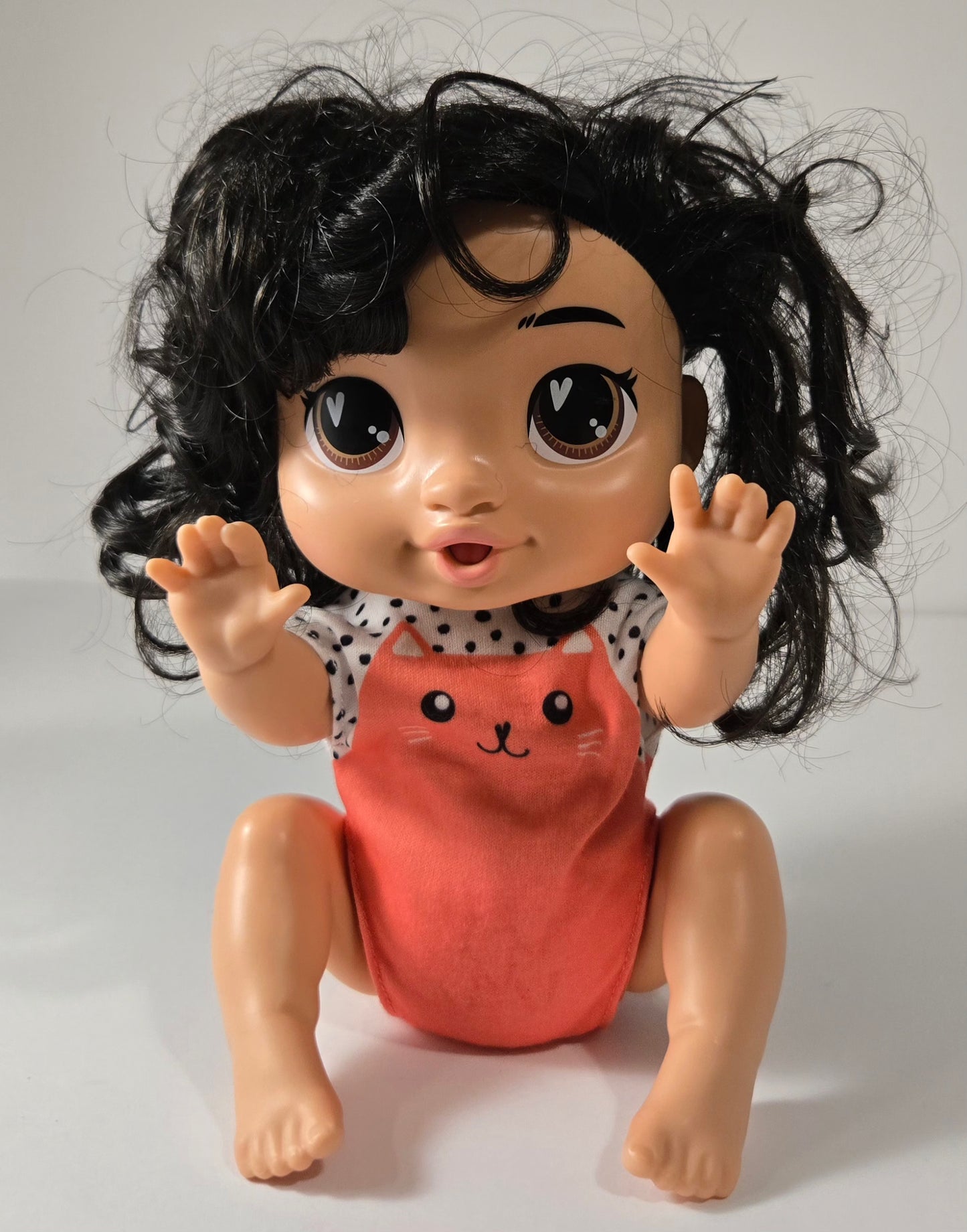 Baby Alive Crawl 'n Play Katie Kat Doll with black hair crawling across floor – interactive toy for toddlers