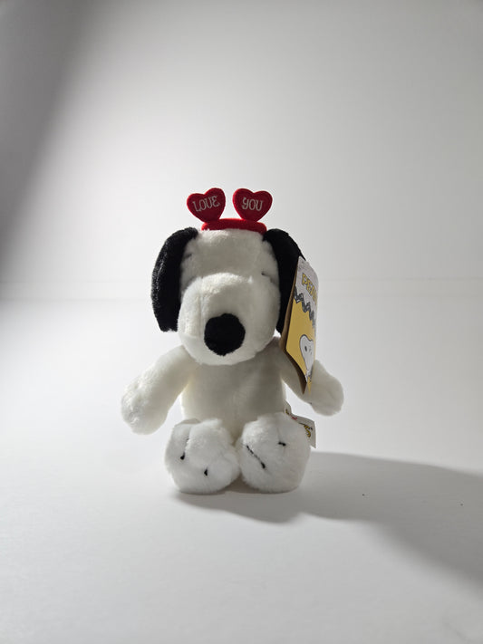 Snoopy plush toy sitting upright with classic black and white features – Peanuts stuffed animal