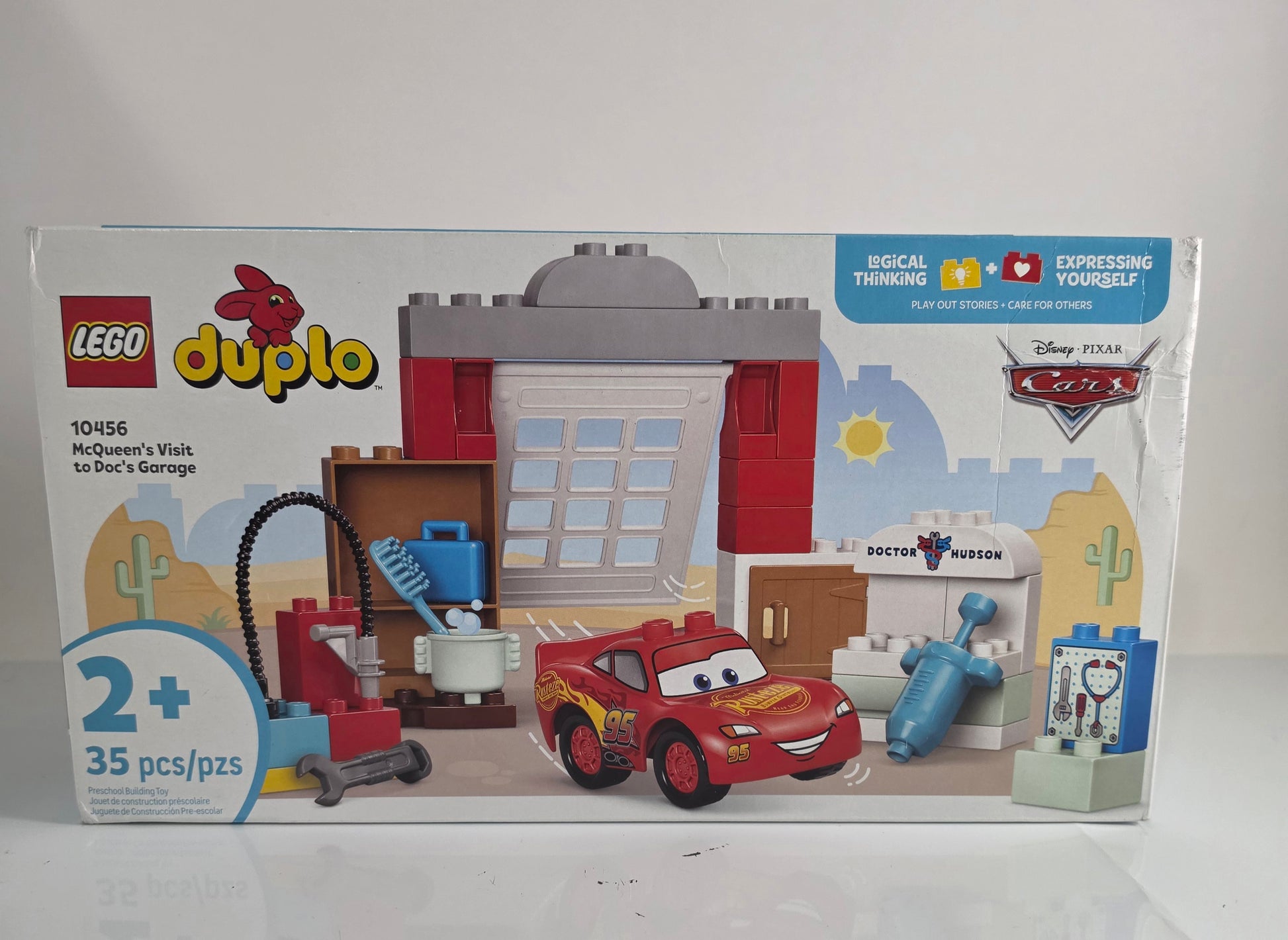 LEGO Duplo toy set packaging with a red car and building blocks on a white background