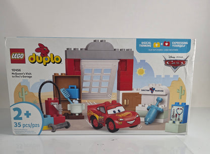 LEGO Duplo toy set packaging with a red car and building blocks on a white background